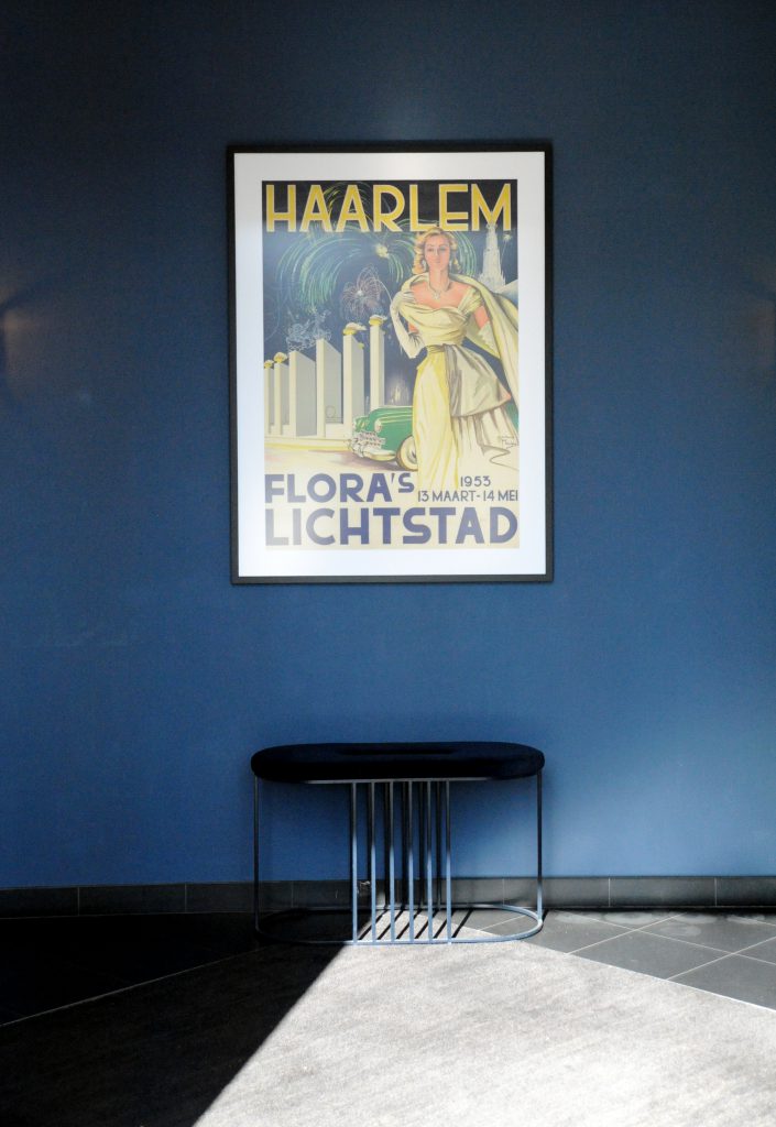 vintage poster in hotel lobby that reads Haarlem Flora's Lichtstad 1953 13 Maart - 14 Mei