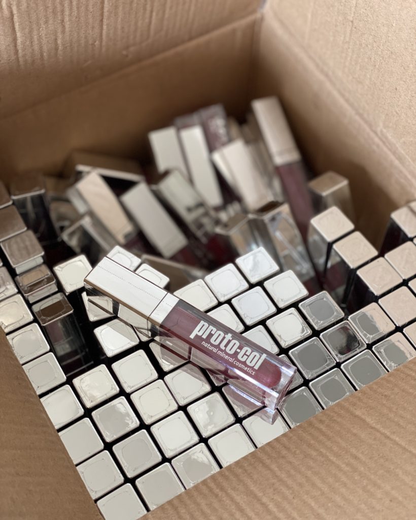 box of lipglosses with silver lids