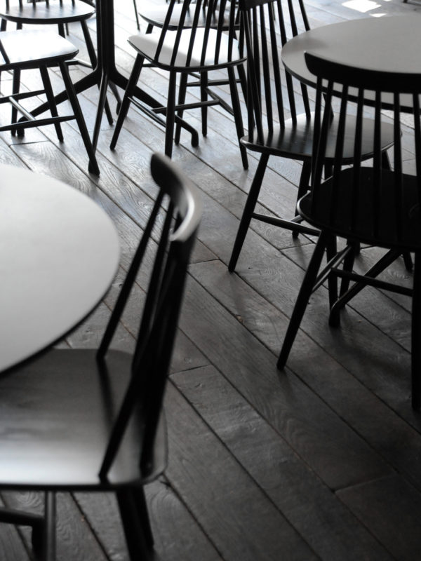 black chairs and tables on a black floor