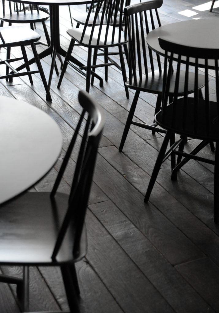 black chairs and tables on a black floor